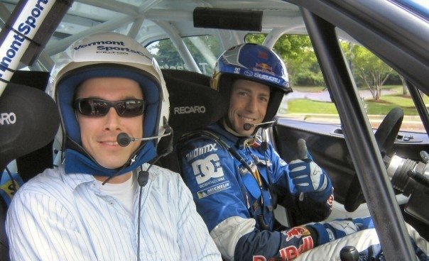 Will Yandell with Travis Pastrana inside a rally car at a Red Bull event
